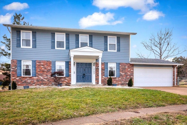 view of front of house with a garage and a front lawn