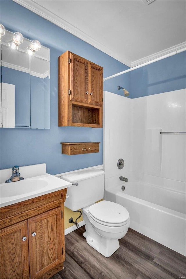 full bathroom with bathtub / shower combination, toilet, crown molding, vanity, and hardwood / wood-style floors