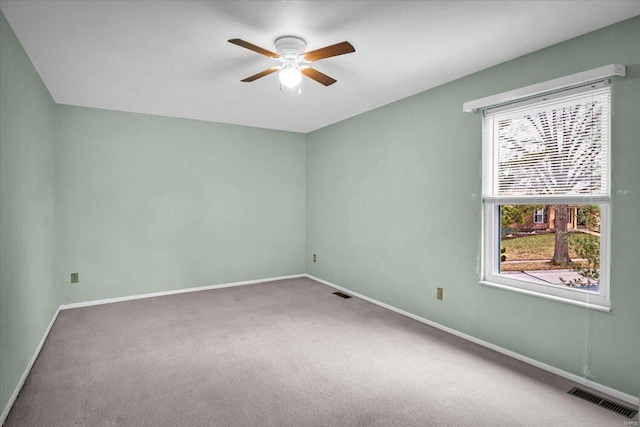 carpeted empty room featuring ceiling fan