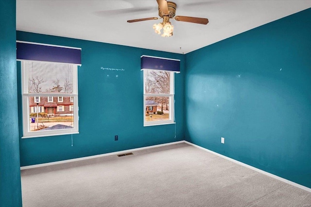 empty room with carpet flooring and ceiling fan