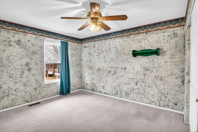 carpeted spare room with ceiling fan