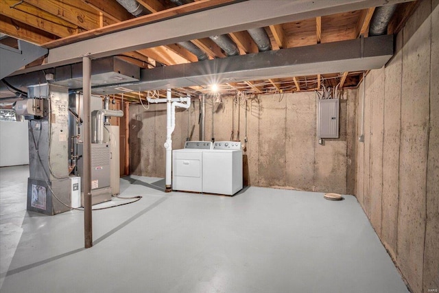 basement featuring electric panel and washer and clothes dryer