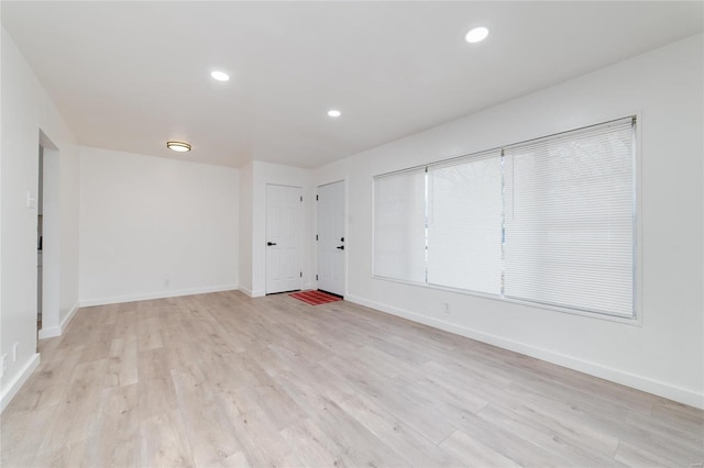 spare room with light wood-type flooring