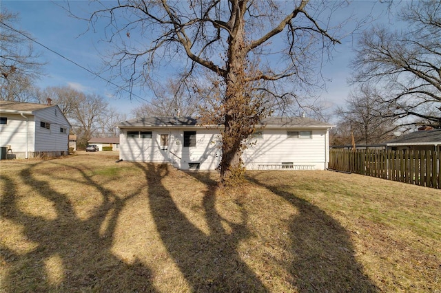 back of house featuring central AC and a lawn