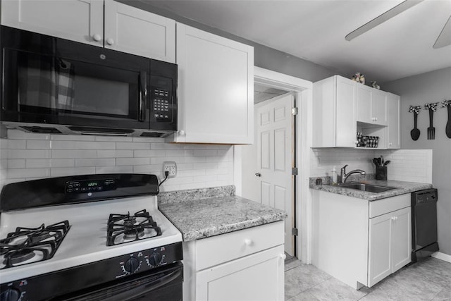 kitchen featuring white cabinetry, sink, decorative backsplash, light stone counters, and black appliances