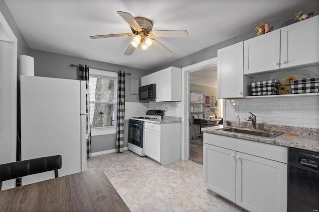 kitchen featuring sink, ceiling fan, white cabinetry, tasteful backsplash, and black appliances