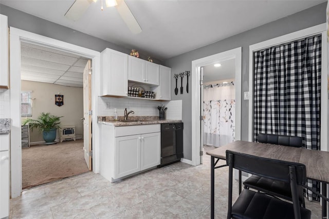 kitchen featuring white cabinetry, dishwasher, light stone counters, and decorative backsplash