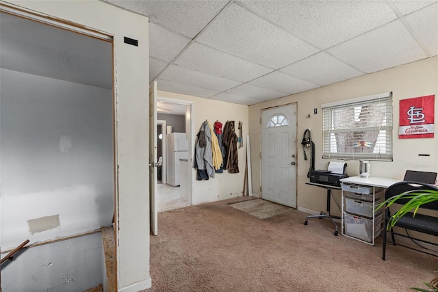 carpeted entryway with a drop ceiling