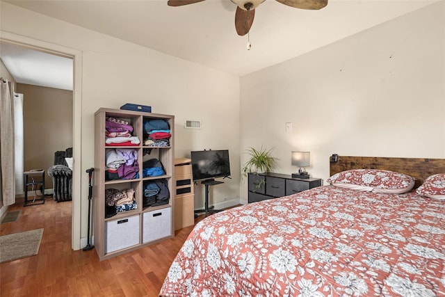 bedroom with ceiling fan and hardwood / wood-style floors