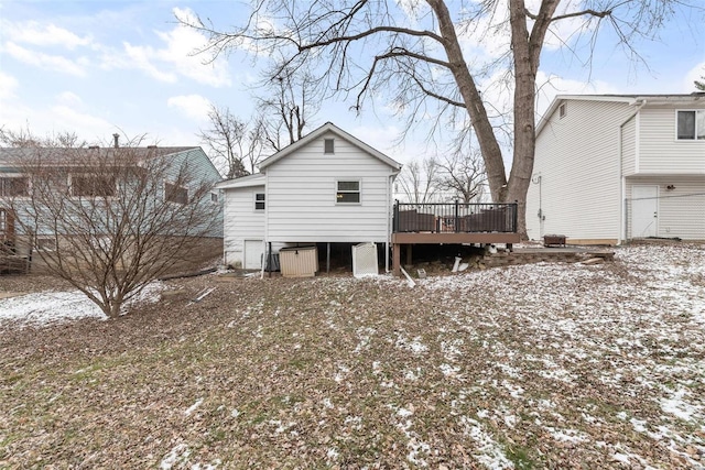 snow covered house with a wooden deck