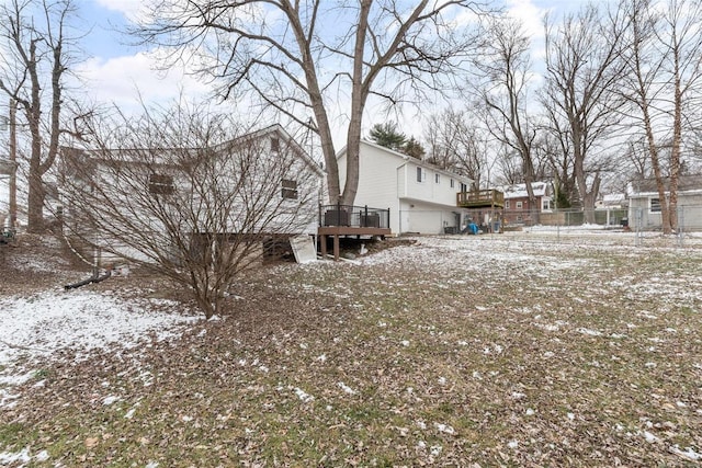 yard covered in snow with a wooden deck