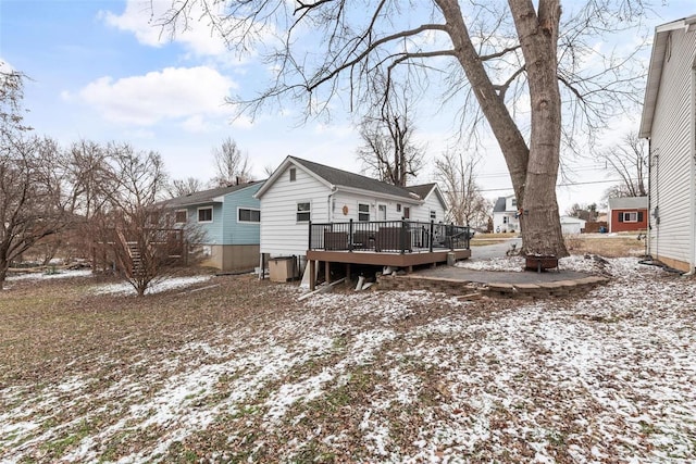 snow covered property featuring a wooden deck