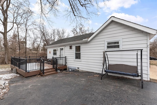 rear view of property with a deck