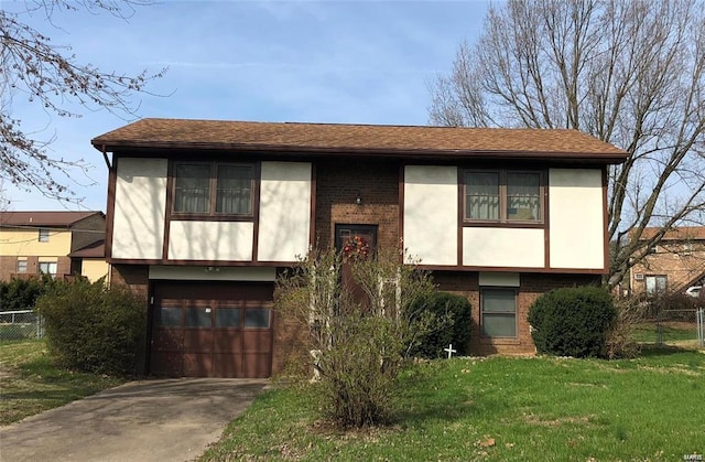 view of front of house with a garage and a front lawn