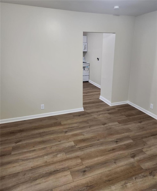 spare room featuring dark hardwood / wood-style flooring