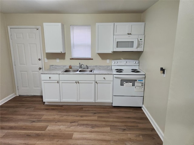 kitchen featuring dark hardwood / wood-style floors, white cabinetry, sink, and white appliances