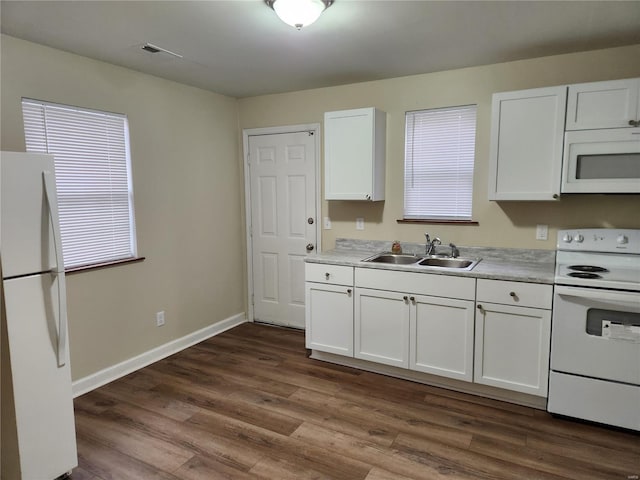 kitchen featuring white cabinetry, white appliances, and sink