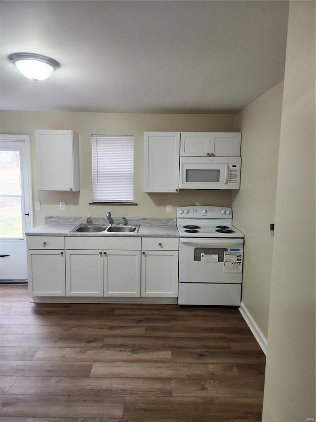 kitchen featuring white appliances, sink, and white cabinets