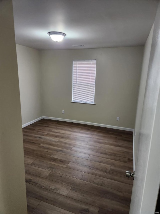 empty room featuring dark wood-type flooring