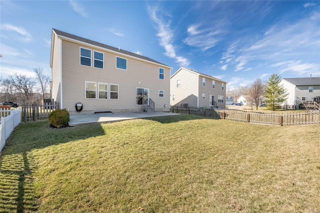 rear view of property with entry steps, a yard, a patio, and a fenced backyard