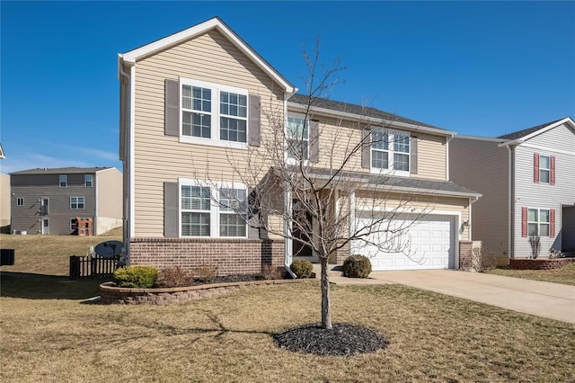 traditional-style home featuring concrete driveway, brick siding, an attached garage, and a front yard