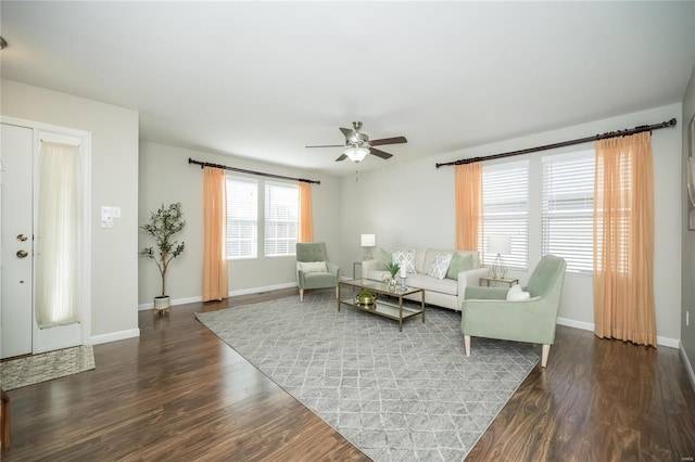 living area featuring ceiling fan, baseboards, and wood finished floors