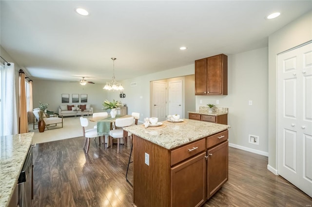 kitchen with recessed lighting, open floor plan, decorative light fixtures, and dark wood-style flooring