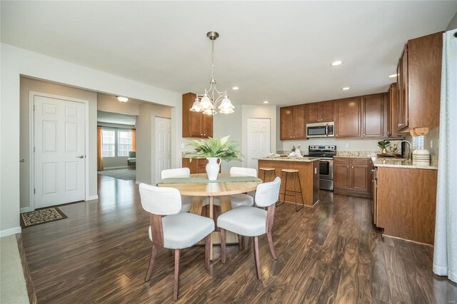 dining space with a chandelier, baseboards, dark wood finished floors, and recessed lighting