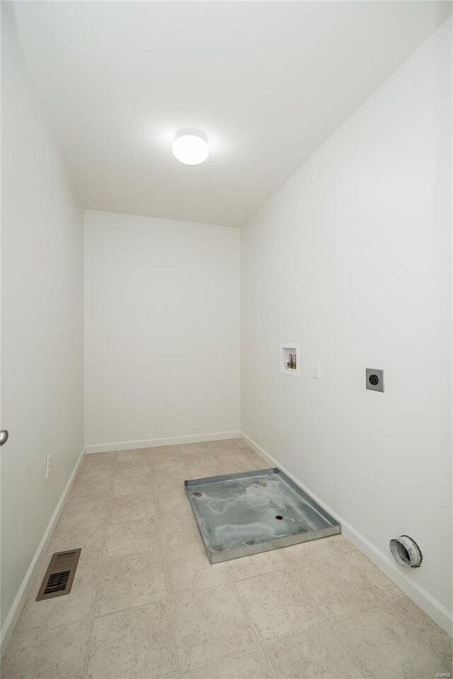 laundry area with hookup for an electric dryer, laundry area, washer hookup, visible vents, and baseboards