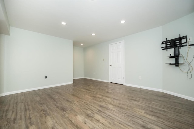 empty room with recessed lighting, baseboards, and wood finished floors