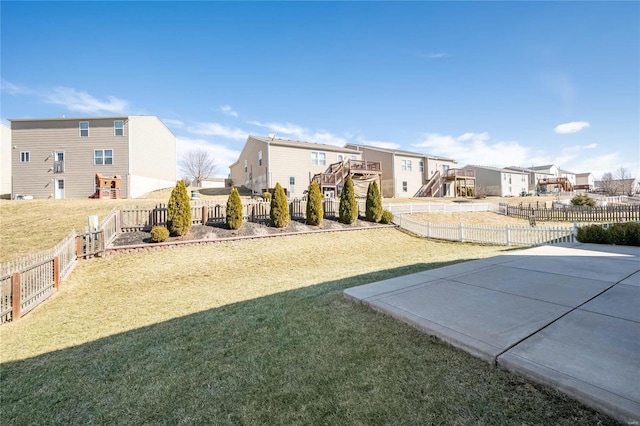 view of yard featuring a fenced backyard and a residential view