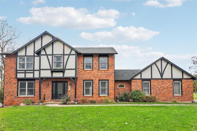 tudor house featuring a front lawn