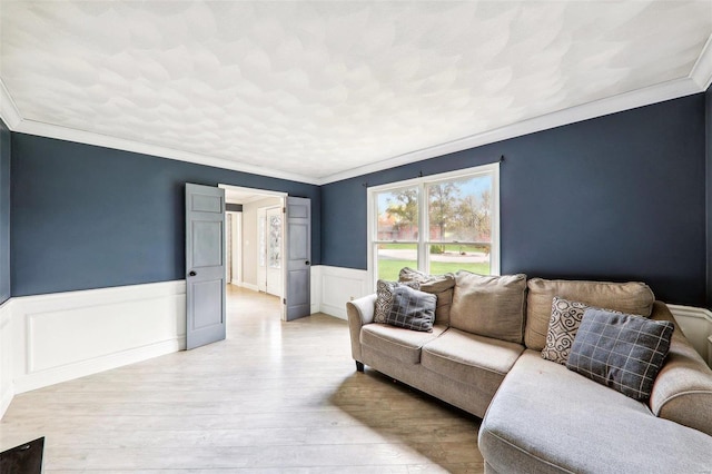 living room featuring crown molding and light wood-type flooring