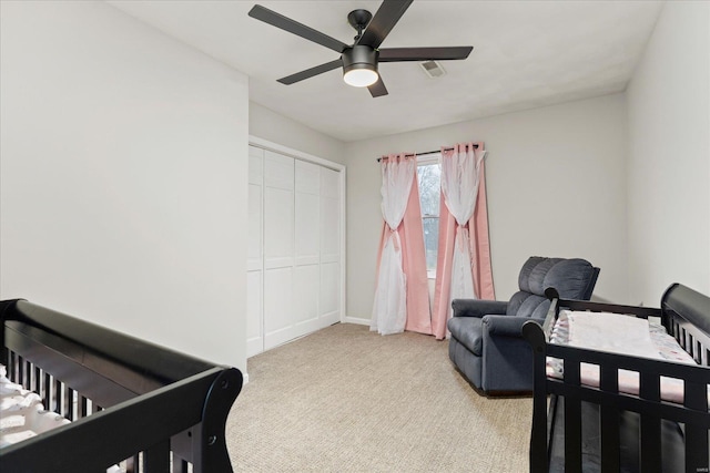 carpeted bedroom featuring a closet and ceiling fan