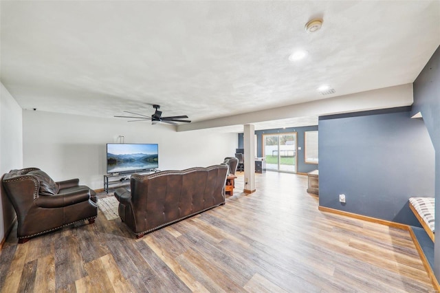 living room featuring hardwood / wood-style floors and ceiling fan