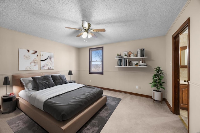 bedroom featuring ceiling fan, light carpet, and a textured ceiling