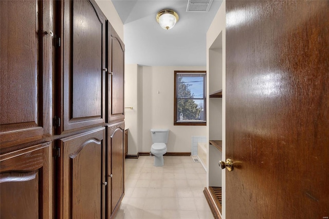 bathroom featuring toilet and a bath