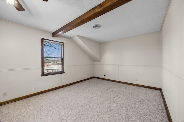 bonus room with ceiling fan, light colored carpet, a textured ceiling, and vaulted ceiling with beams