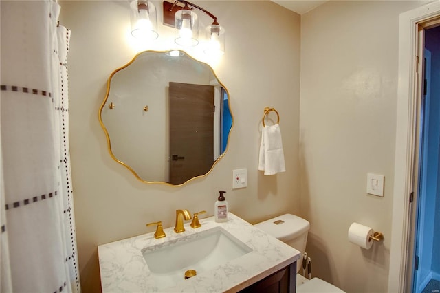 bathroom with toilet and vanity