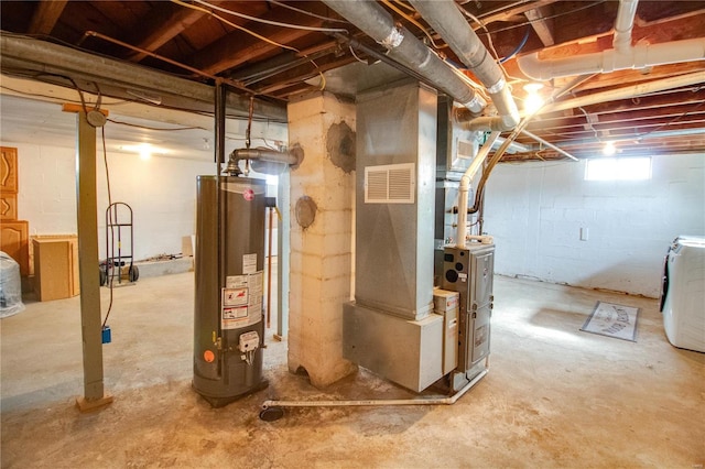 basement featuring water heater, independent washer and dryer, and heating unit