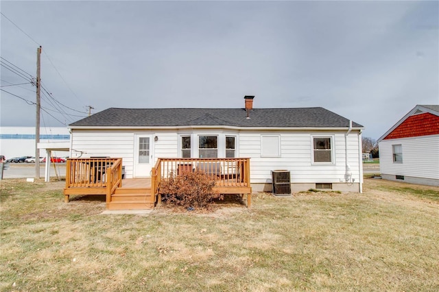 back of property featuring a deck, a yard, roof with shingles, and cooling unit