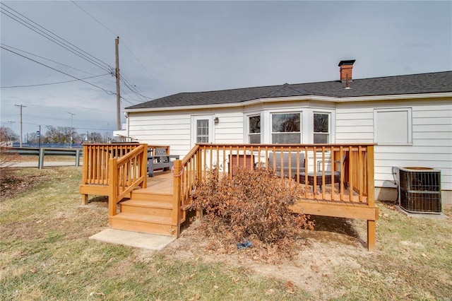 deck with a lawn and central air condition unit