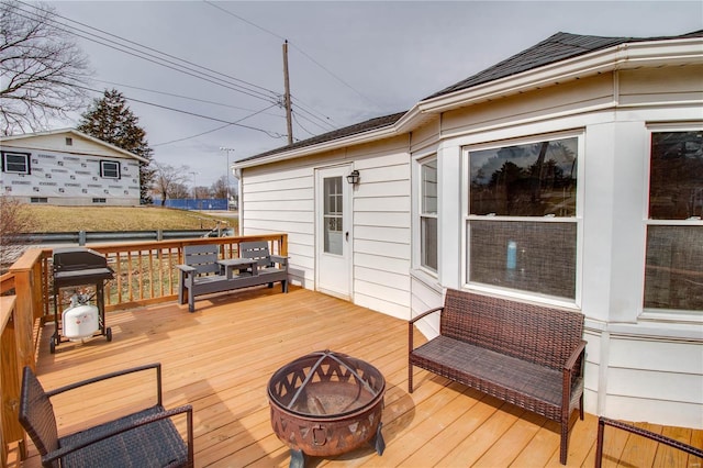 deck featuring a grill and a fire pit