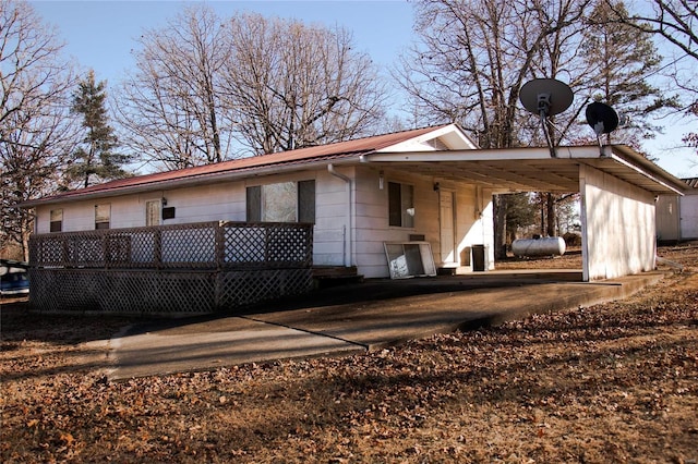 rear view of property with a carport