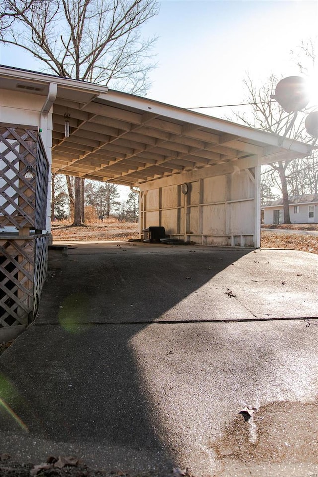 view of parking / parking lot featuring a carport