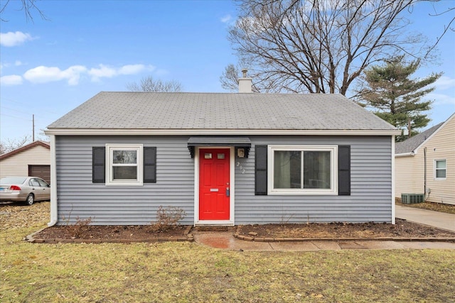 view of front of home featuring cooling unit and a front yard