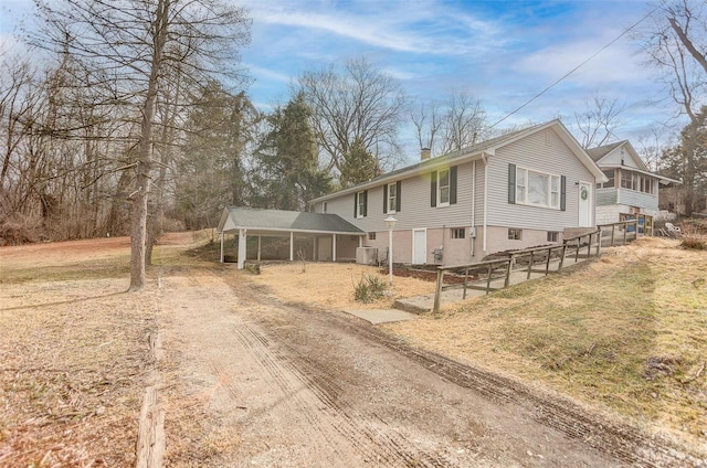 view of front of house with a sunroom and cooling unit