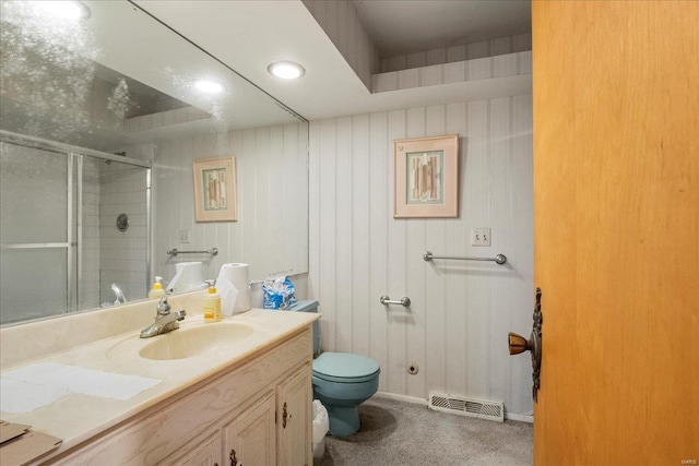 bathroom featuring visible vents, a shower stall, toilet, and vanity