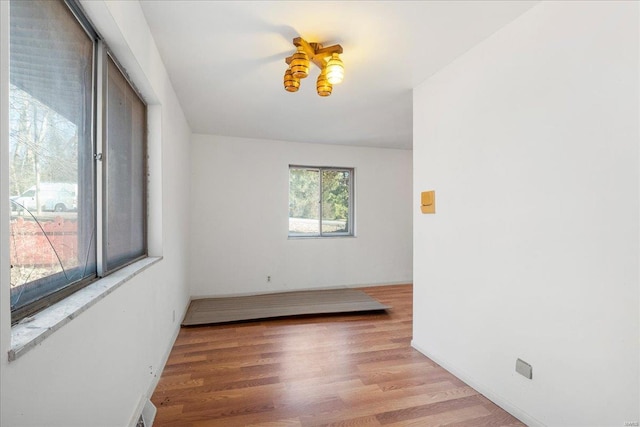 unfurnished room featuring light wood-type flooring and baseboards