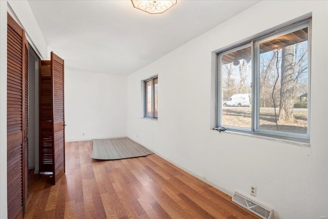 spare room with visible vents and wood finished floors